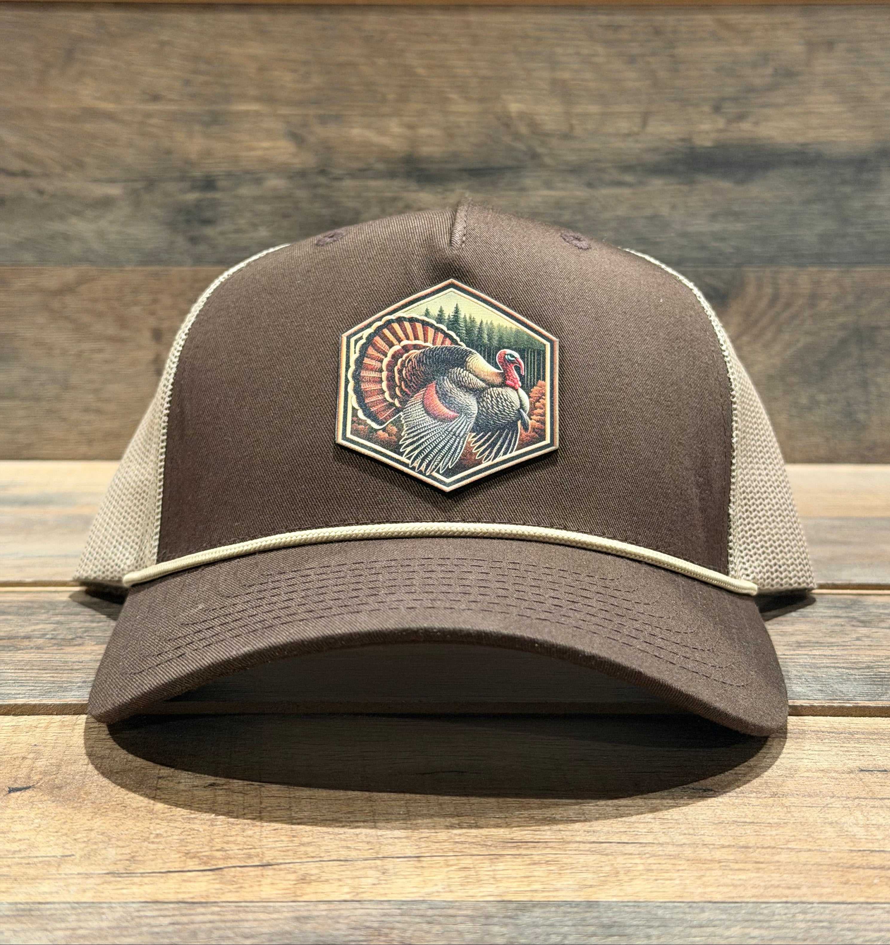 Brown cap with a rooster emblem on a wooden background