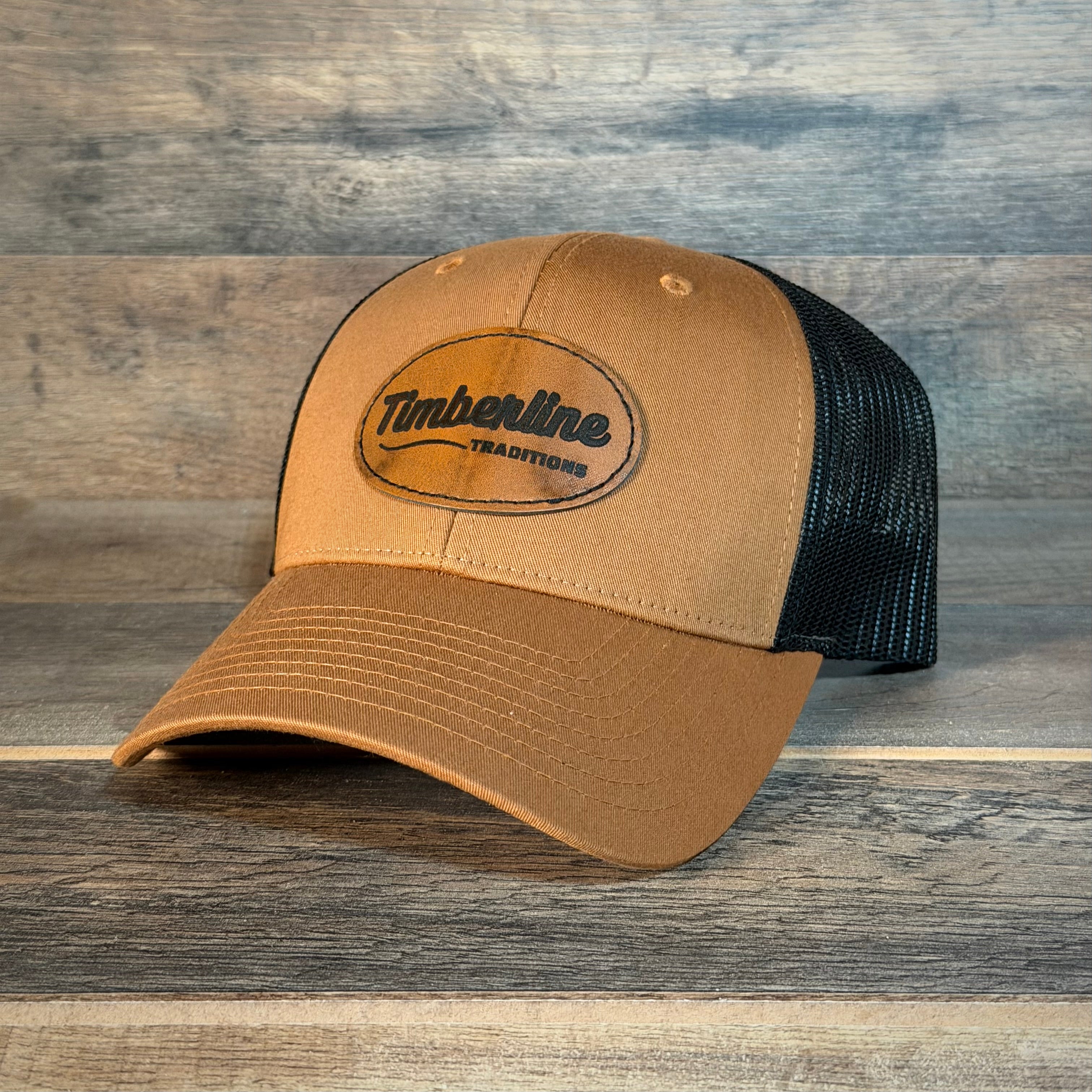 Brown trucker cap with black mesh back on a wooden surface