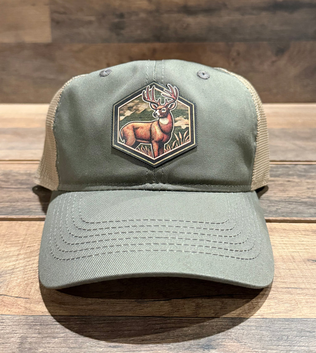 Green cap with deer patch on a wooden surface