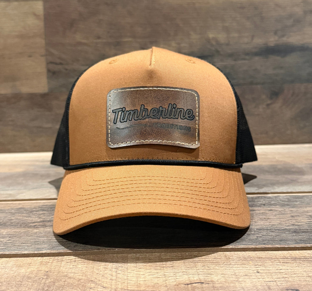 Tan cap with a Timberline logo on a wooden surface