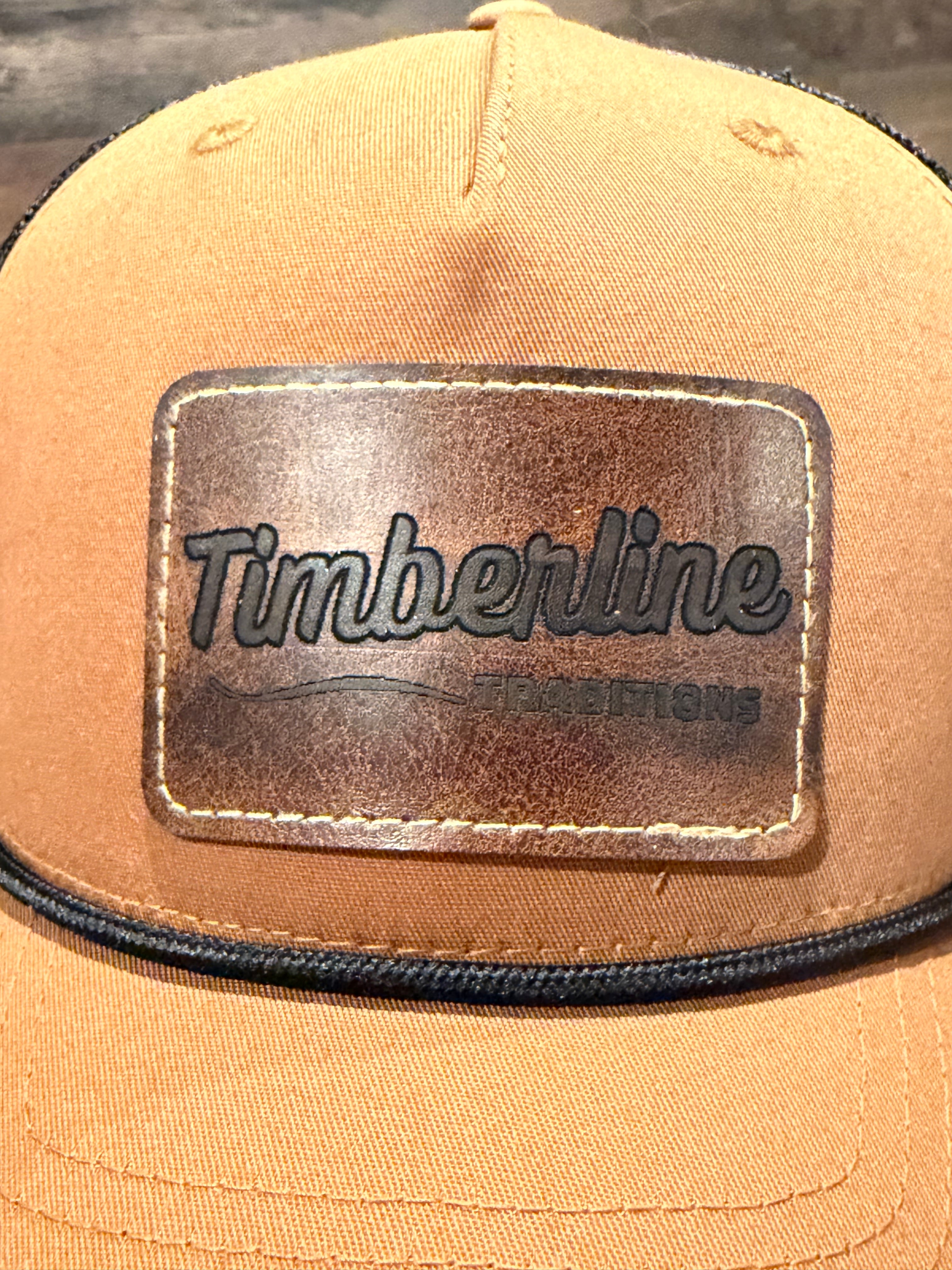 Tan cap with Timberline logo on a wooden surface