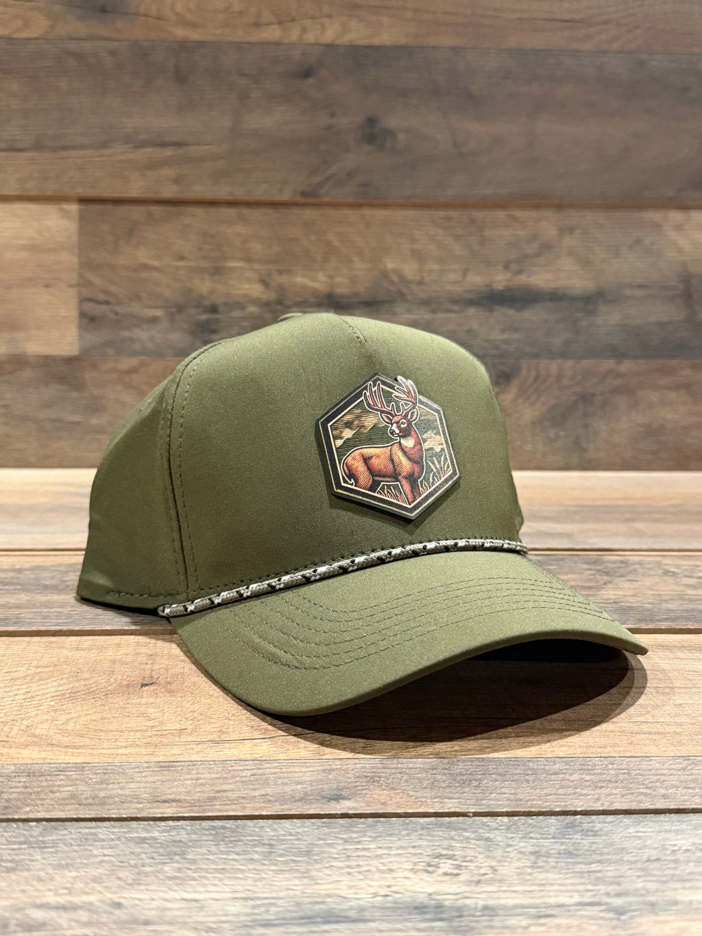 Green cap with a patch on a wooden surface