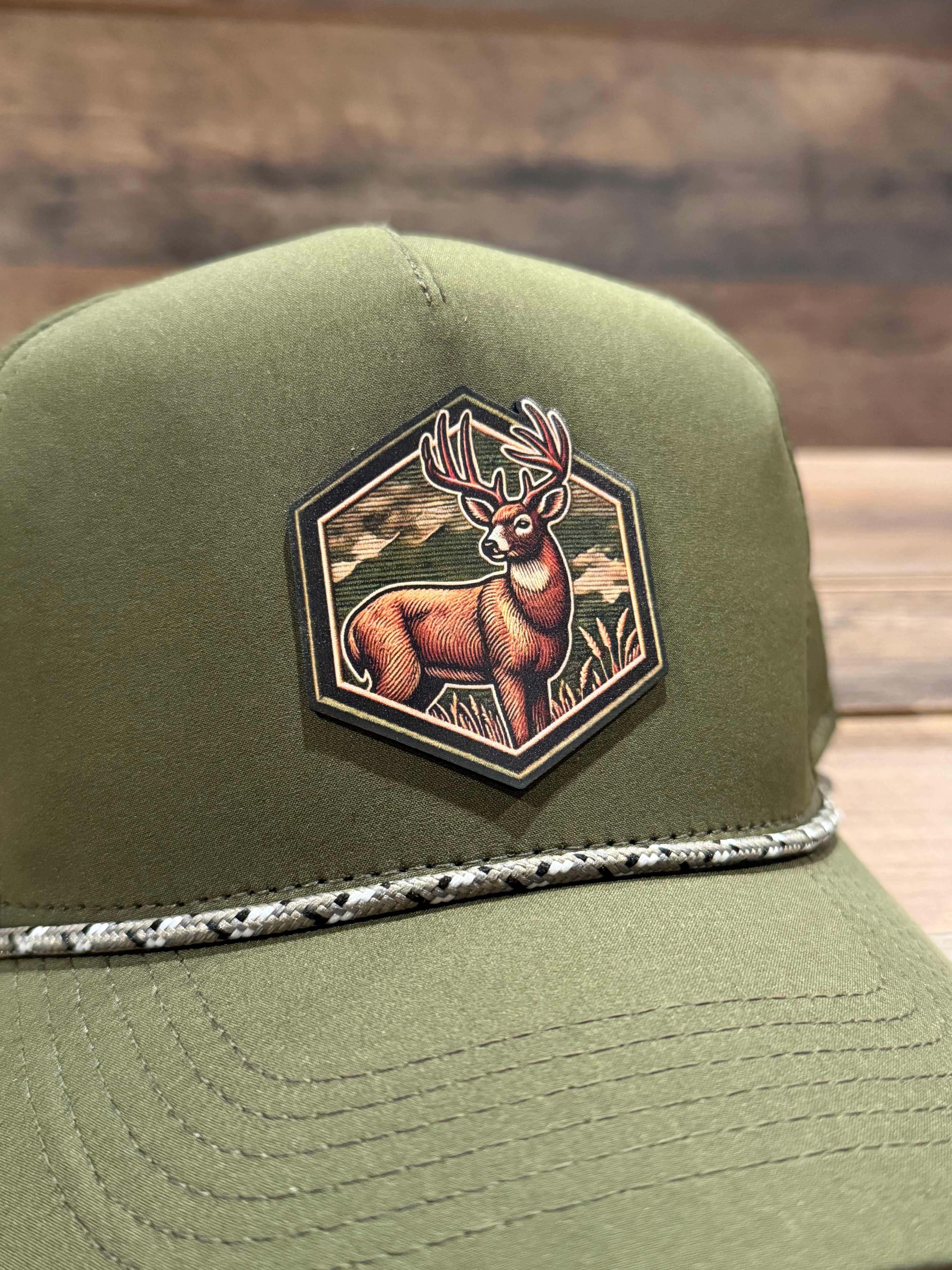 Green cap with a decorative patch featuring a stylized animal design on a wooden background