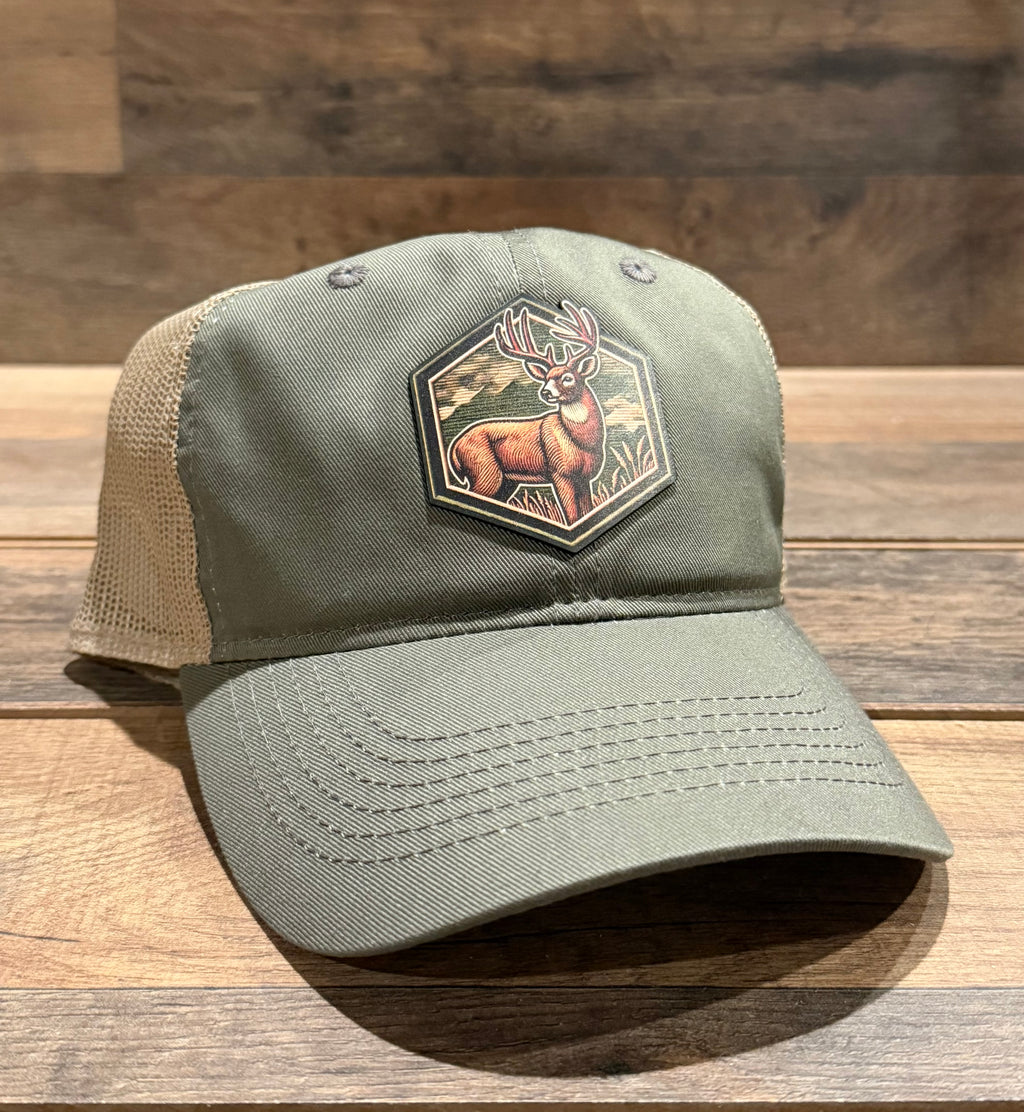 Green cap with a deer emblem on a wooden surface