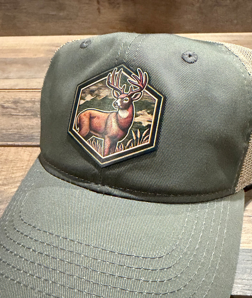 Green cap with a deer patch on a wooden surface